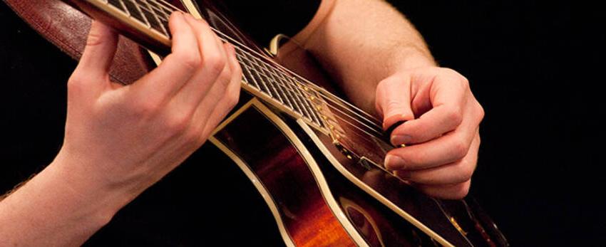 Photo of student playing guitar